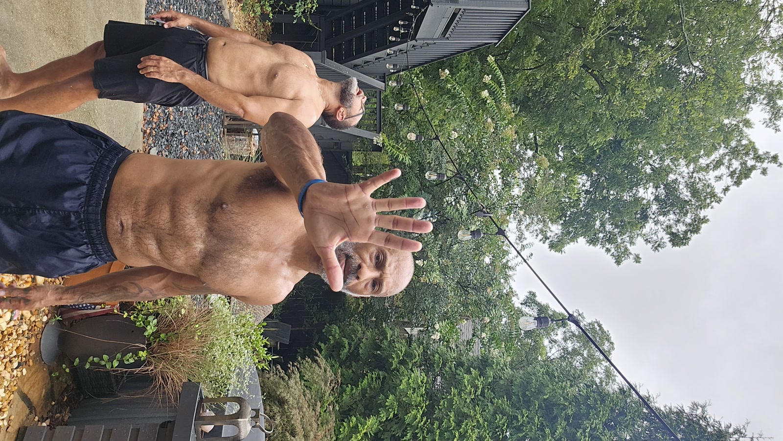 Mike and Jason after a long ruck hike, hands up — 'no photos please'